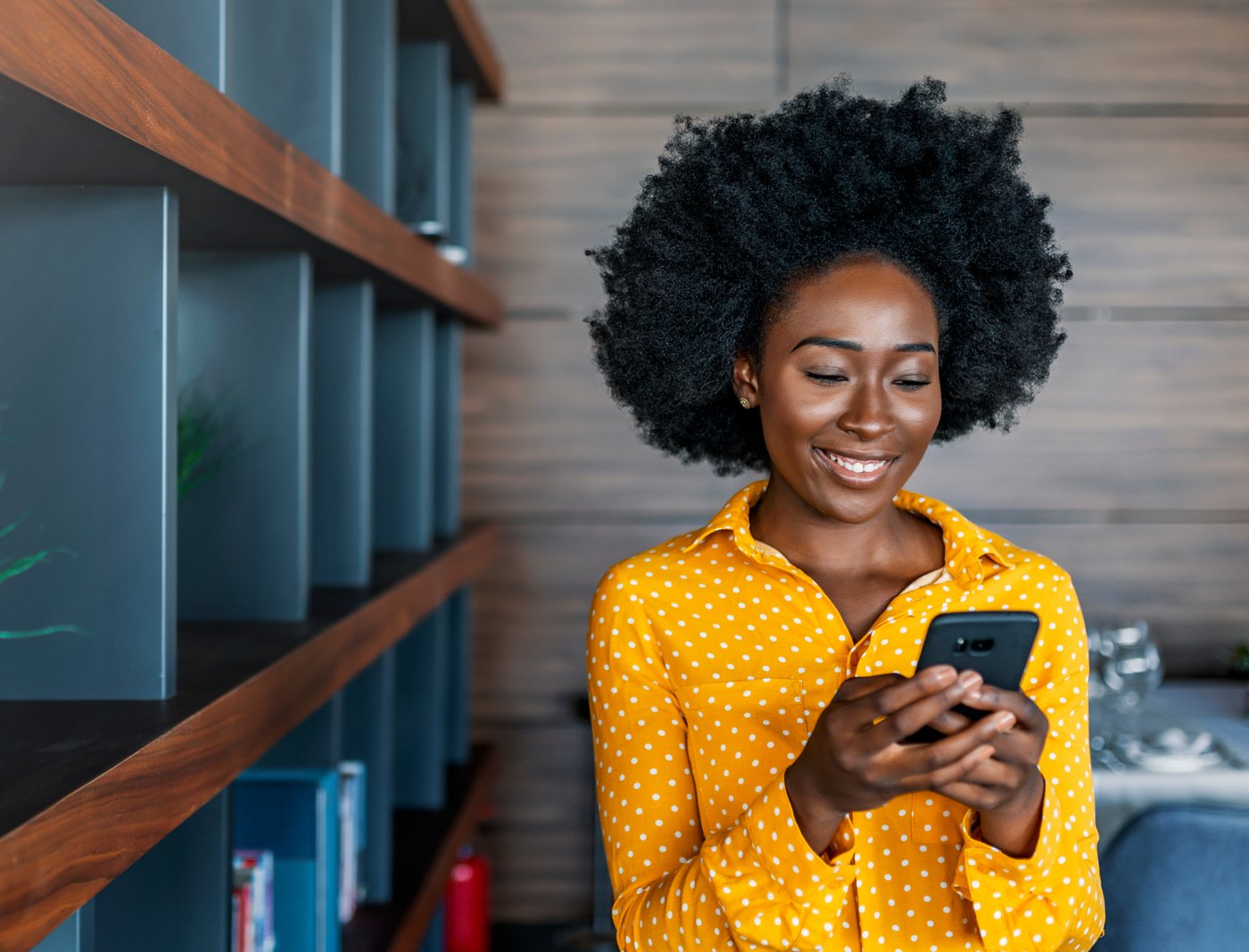 A MoMo customer using mobile money on her phone